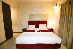 a bedroom with a large bed in a room at Nestoa Suites - Benson Town in Bangalore