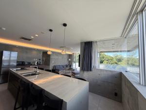 a kitchen with a counter and a large window at Emerald Ocean Villa in Onna +40 photos