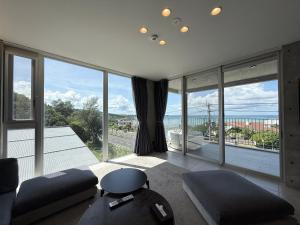a large living room with a large glass window at Emerald Ocean Villa in Onna
