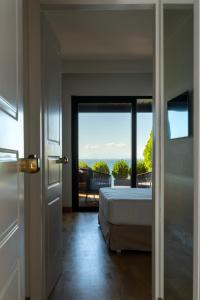 a bedroom with a bed and a view of the ocean at Coral Hotel Athens in Athens