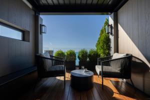 a patio with a table and chairs on a deck at Coral Hotel Athens in Athens