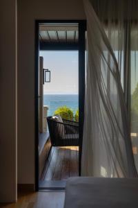 a door to a balcony with a view of the ocean at Coral Hotel Athens in Athens +115 photos