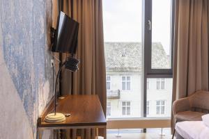 a hotel room with a desk and a window at Scandic Victoria Florø in Florø