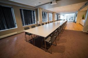 a large conference room with a long table and chairs at Scandic Victoria Florø in Florø