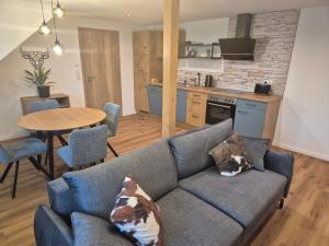 a living room with a couch and a table and a kitchen at FeWo Zenk Stublang in Bad Staffelstein