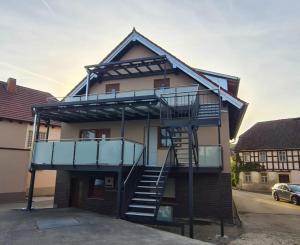 a house with a spiral staircase in front of it at FeWo Zenk Stublang in Bad Staffelstein