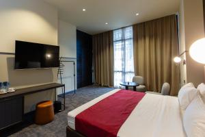 Postel nebo postele na pokoji v ubytování Hotel NOBO Tbilisi