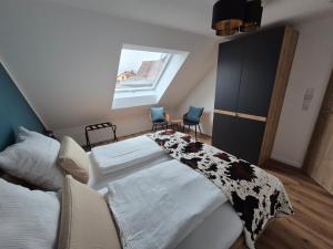 a bedroom with a bed with a black and white blanket at FeWo Zenk Stublang in Bad Staffelstein