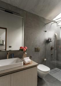 a bathroom with a sink and a toilet and a shower at LohonoStays Amani Villa 10A in Coonoor