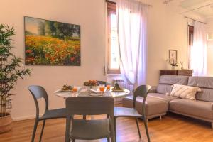 a living room with a table and a couch at Maison 161 in Rieti