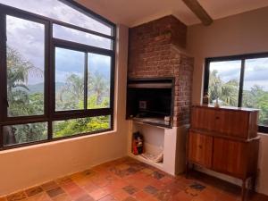 a living room with large windows and a fireplace at Hooggelegen Estate in White River