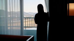 a person standing in front of a window looking out at 대전 유성 낙원온천호텔 by 아늑 in Yusŏng