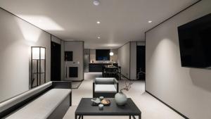 a living room with a couch and a table at 대전 유성 낙원온천호텔 by 아늑 in Yusŏng