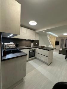 a kitchen with a sink and a stove top oven at Appartement cosy 2 chambres in Jougne