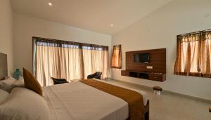科代卡纳尔Banana Tree Retreat的一间配有床和平板电视的酒店房间