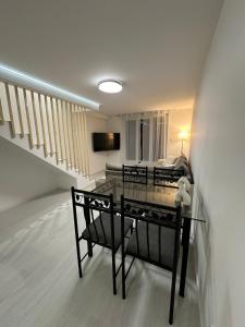 a living room with a table and a couch at Appartement cosy 2 chambres in Jougne
