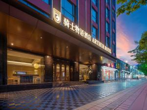 a building with a sign on the side of it at Arthur Hotel Baiyun Station Xinshixu Subway Station Guangzhou in Guangzhou