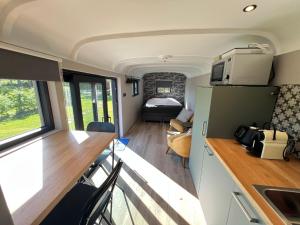 a kitchen and living room in a tiny house at Pine Tree Tiny cottage in Rochefort