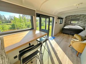 a tiny house with a desk and a bedroom at Pine Tree Tiny cottage in Rochefort