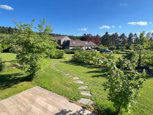 a garden with a stone path and apple trees at Pine Tree Tiny cottage in Rochefort