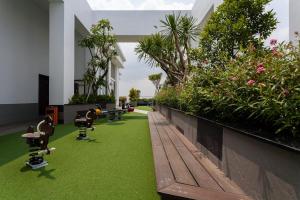 a building with skateboards on the grass and plants at The Lume Studio - Tresor D4 in Ho Chi Minh City