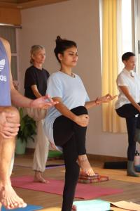 a woman is doing yoga in a room with other people at Happy Homes by Yoga & Smiles, Upper Tapovan in Rishīkesh