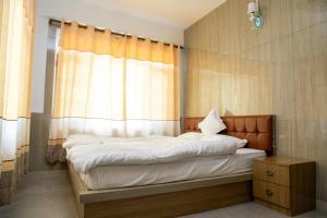 Postel nebo postele na pokoji v ubytování Hotel Sonam + 4 fotografie