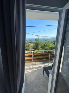 a view from a sliding glass door of a balcony at Holiday Home Nature Plesivica in Jastrebarsko