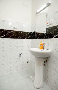 un bagno bianco con lavandino e specchio di Amno Elite Suites a Naivasha