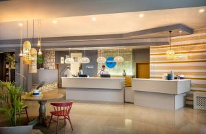 a kitchen with a person standing in the background at Sunny Porec by Valamar in Poreč
