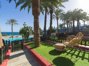 a resort with palm trees and a swimming pool at Blue Horizon Retreat in Playa del Aguila