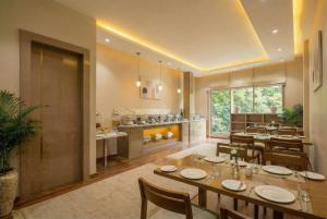 a dining room and kitchen with a table and chairs at Dahabi Venue Premium- Free Airport Pick up or Drop in New Delhi