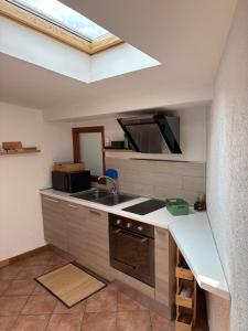 a kitchen with a sink and a stove at Ca baracot in Lanzo Torinese +18 photos