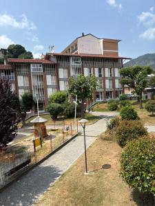 a large building with a fence in front of it at Ca baracot in Lanzo Torinese