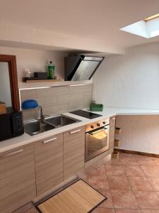 a kitchen with a sink and a stove at Ca baracot in Lanzo Torinese