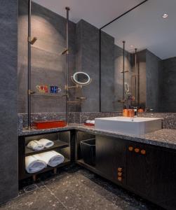a bathroom with a sink and a mirror at Arthur Hotel Baiyun Station Xinshixu Subway Station Guangzhou in Guangzhou +71 photos