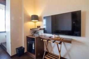 a room with a large flat screen tv on a wall at Gulf Hotel Mumbai- The Boutique Hotel Colaba Mumbai in Mumbai