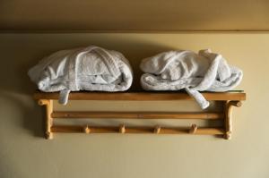 two towels are sitting on a wooden shelf at Helenekilde Badehotel in Tisvildeleje +73 photos
