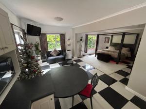 a living room with a christmas tree and a table at Innessfree Cottage in Doordrift
