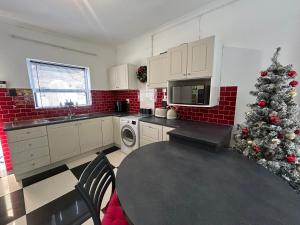 a kitchen with a christmas tree in the corner at Innessfree Cottage in Doordrift