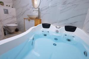 a white bath tub in a bathroom with a toilet at Moses Luxury apartment 38 jerusalem in Safed +25 photos