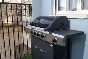 a grill sitting on top of a stove next to a building at Moses Luxury apartment 38 jerusalem in Safed