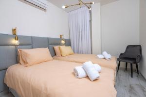 two beds in a room with towels on them at Moses Luxury apartment 38 jerusalem in Safed