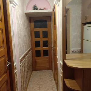 a hallway with a door in a kitchen at Квартира in Sumy