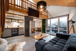 a living room with a couch and a fireplace at LES-wellness in Pastviny