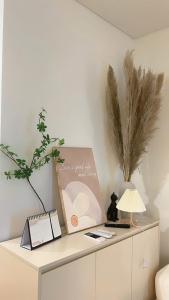 a white cabinet with a lamp and a picture on it at Gia An Homestay in Phú Thú