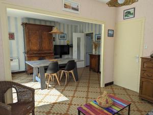 a living room with a table and chairs at Villa 100m plage in La Faute-sur-Mer