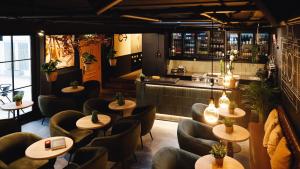 a restaurant with tables and chairs and a bar at Zoom Hotel in Brussels