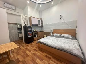 a bedroom with a large bed and a kitchen at AP Home in Ho Chi Minh City +40 photos
