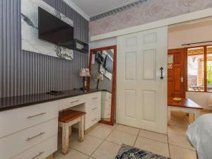 a bedroom with a bed and a tv on the wall at St. Lucia Safari Lodge in St Lucia